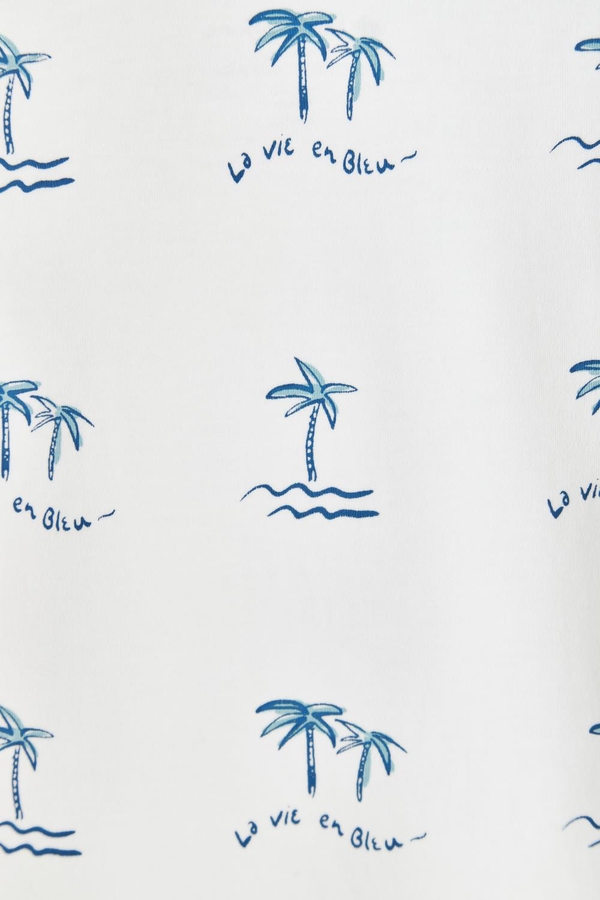 Palms Printed Short Sleeve Tee with round necklace made with soft pima cotton. Pattern view.