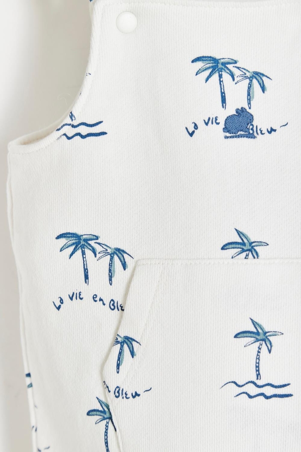 Palms Short Overall with buttoned straps and pockets at the front. Detail view